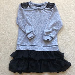 A light gray with black ruffled bottom dress.